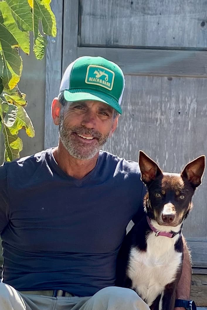 Chris with McNab dog in garden - community and partnership